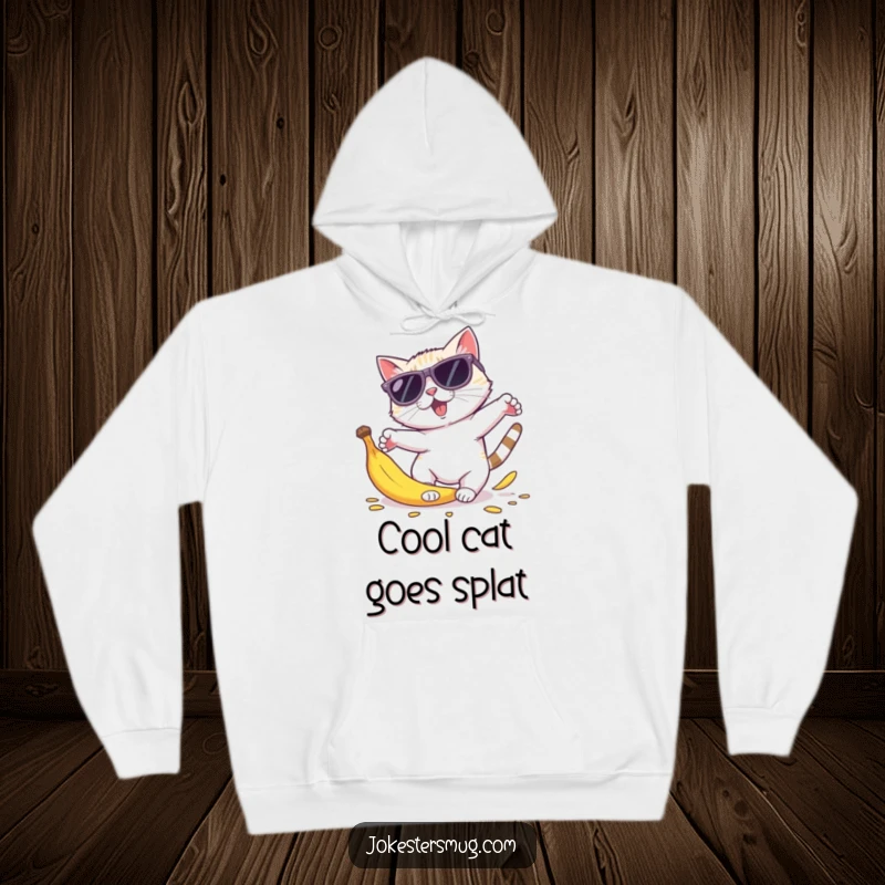 Funny cat sunglasses hoodie showing a cat in oversized shades tripping on a banana peel, body parts comically scattered.