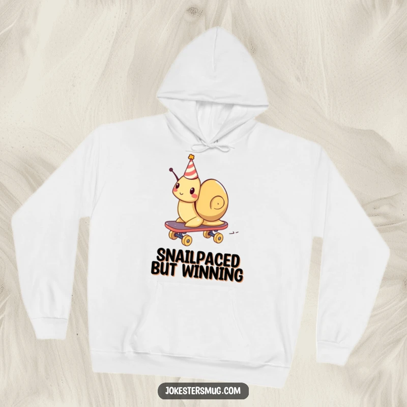 Funny hoodie depicting a snail in a party hat, surprisingly fast on a skateboard, embodying joyful movement.