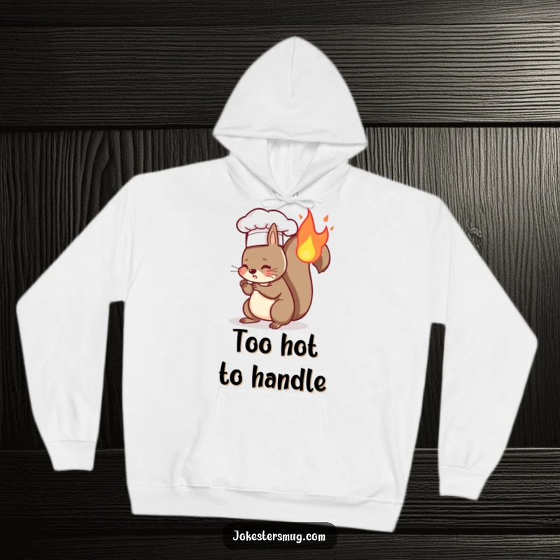 Funny hoodie featuring a squirrel chef with a tiny hat having accidentally set its tail on fire, a humorous cooking scene.