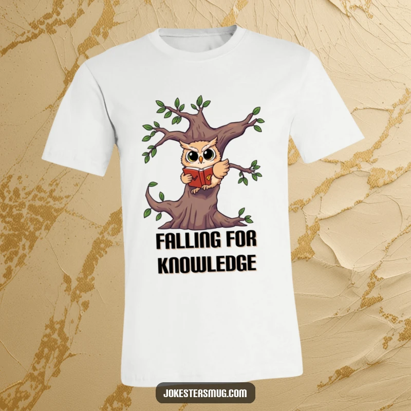 Funny t-shirt print of a startled owl falling from a tree branch, tightly clutching a book.