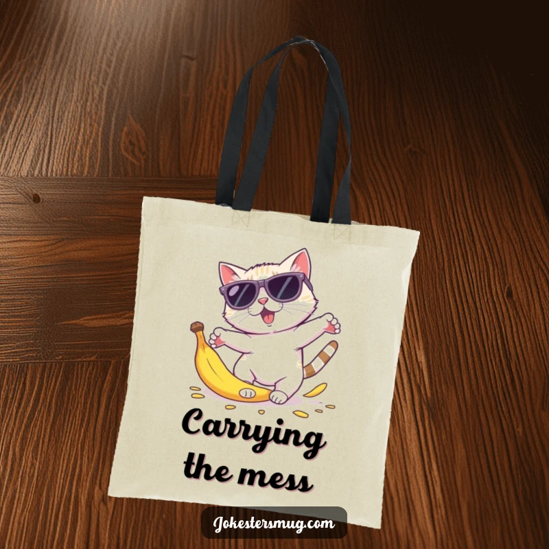 Funny cat sunglasses tote bag depicting a cool cat in oversized shades tripping over a banana peel, body parts comically scattered.