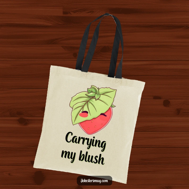 Funny Strawberry Tote Bag: A blushing strawberry tries to hide behind a large leaf. Cute and funny gift for fruit fans.